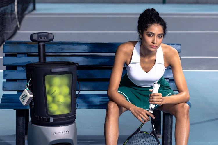 Tennis player resting beside a Lumistar TERO Pro between training sessions