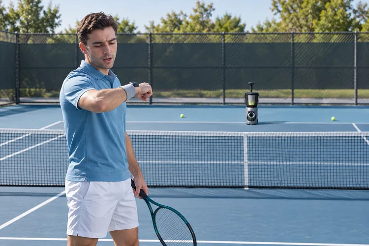 Tennis player using wristband control with Lumistar TERO Pro across the court