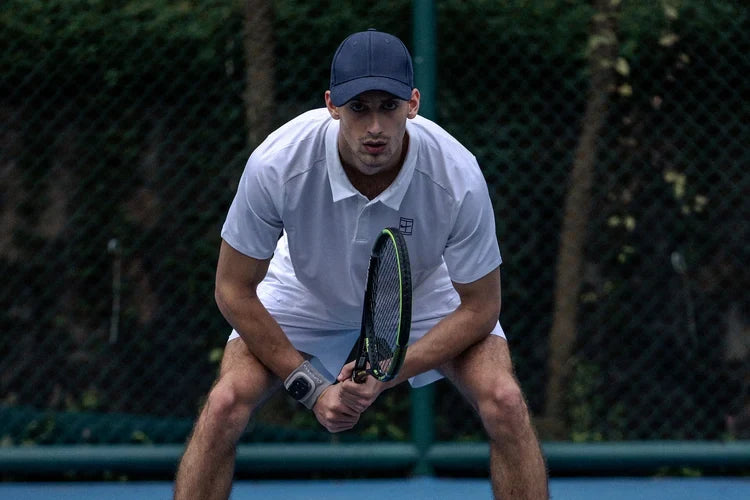 Tennis player preparing for a return during an outdoor practice session