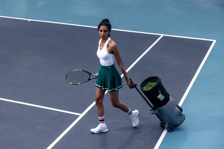 Tennis player rolling a Lumistar TERO Pro across a blue court